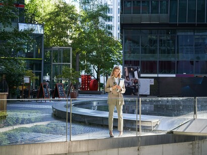 A woman in a modern urban environment designed with openness and accessibility, symbolising CPTED's approach to creating inclusive and secure public spaces