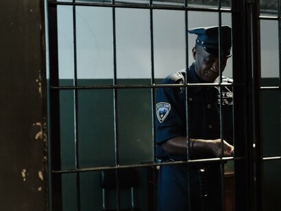 Police officer unlocking a cell