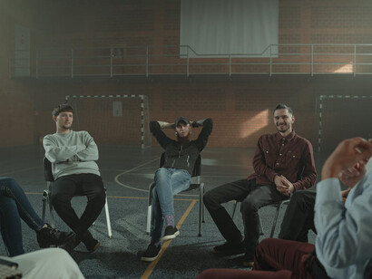 Men gather in a circle, confronting the shocking prevalence of sexual abuse society, reflecting on their roles and responsibilities in dismantling toxic masculinity