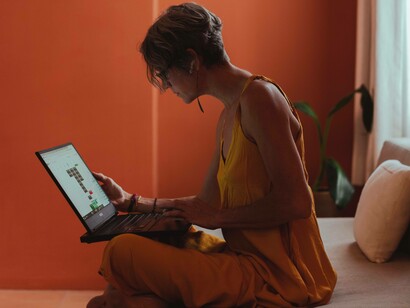 A woman looking over data on her laptop to better cope with the current wave that preaches "every man for himself"