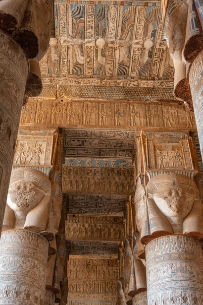 The intricate columns and hieroglyph-covered ceiling of the Dendera Temple in Dendera, Egypt, representing governance expressed through symbols and sacred visual language