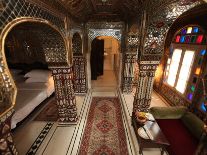 The Sheesh Mahal Suite at Samode Haveli in Jaipur is a beautifully crafted room featuring traditional mirror work and regal decor, India