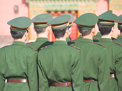 A Chinese military figure from behind, highlighting China's defense strength and technological advancements