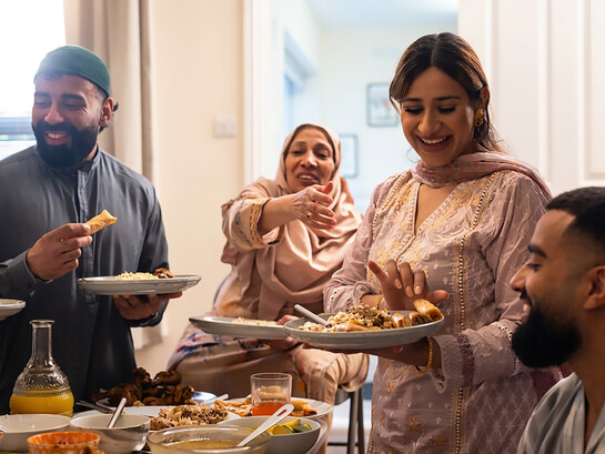 A Pakistani family gathers around the table to enjoy dinner together
