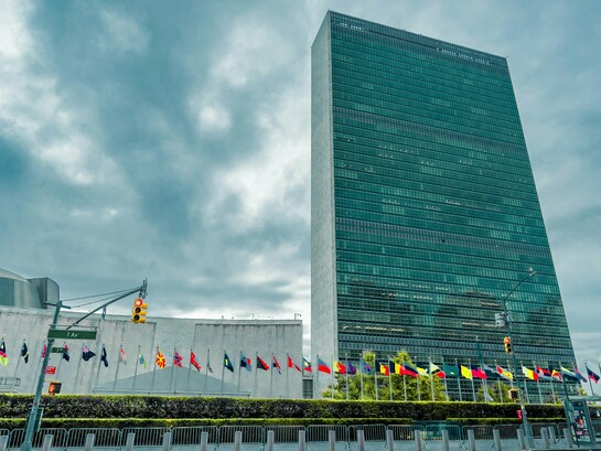 The United Nations Headquarters beneath stormy skies, representing the growing uncertainty surrounding the future of global diplomacy