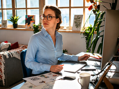 Young designer working from home in a modern home office, reflecting flexible working arrangements
