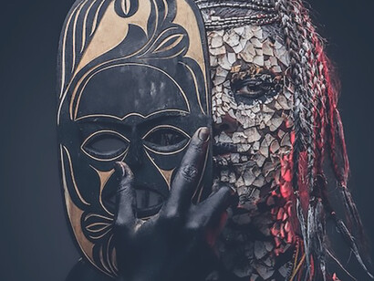 A close-up captures the striking portrait of a witch belonging to an indigenous African tribe, adorned in traditional attire