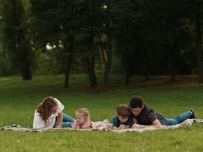 A family cherishes their time outdoors, embracing moments of quiet resilience despite the power outage