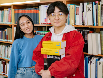 Man and woman talking in a library, exchange students