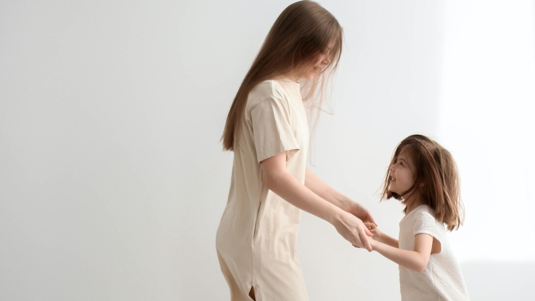 Young girl smiles with joy looking at her mother