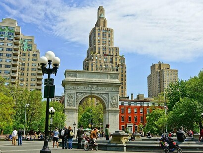The Arch stands as both monument and gateway, watching over the rhythms of daily life in the square