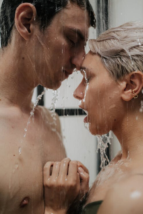 In the throes of passion, the two surrender to the primal pull of emotion, challenging the boundaries of control and logic as they find solace in each other's touch amid the cascading water