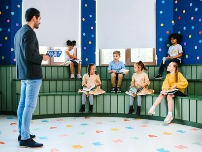 A classroom filled with children eagerly holding books, symbolising the importance of creating a culture of reading from an early age