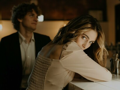 A man and a woman sat at a bar 