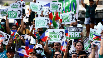 Protesters hold placards and wear symbolic colors as they demand justice and challenge the legitimacy of the ICC’s actions