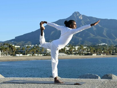 A man performing the Dancer Pose, symbolising the union of discipline and freedom