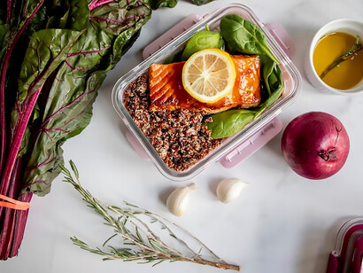 Vibrant slices of lemon rest artfully on a pristine white plastic container, epitomizing the essence of healthy food, food preparation