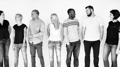 A diverse group of people enjoying themselves together, embodying the values of inclusivity and collaboration within a multicultural workforce