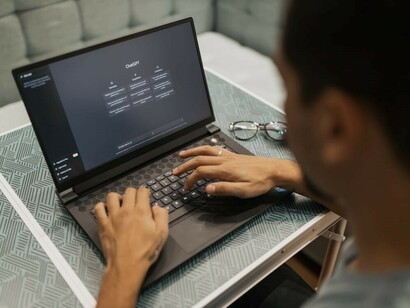 A man conversing with ChatGPT on his computer, experiencing a dynamic interaction with the AI chatbot