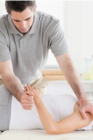 Un quiropráctico tratando los huesos y los músculos de una paciente
