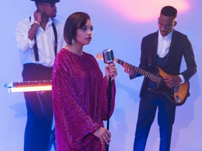 Woman singing with her band