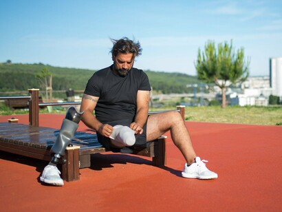 A man getting ready to exercise on a running track, reflecting how fitness can become part of an individualized self-care routine