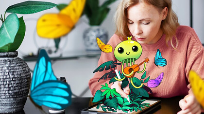 An image of a woman with a tablet device, showcasing her vibrant creativity, brings the concept of coming alive through technology to life