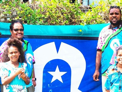 People stands by a Torres Strait Island flag, Queensland, Australia