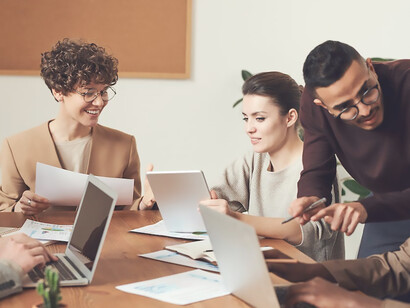In the corporate setting, professionals convene around documents, underscoring the indispensable nature of effective communication for cohesive teamwork and informed decision-making