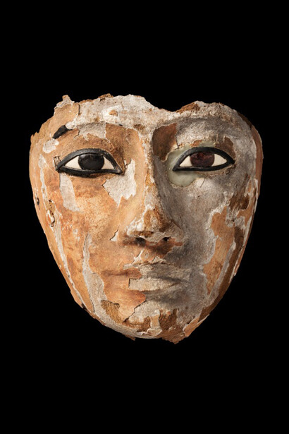 Wooden face with inlaid eyes