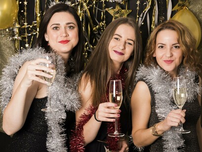 Festive glamour visible through silver garlands and sparkling dresses, representing the spectacle that first drew the protagonist into the mansion
