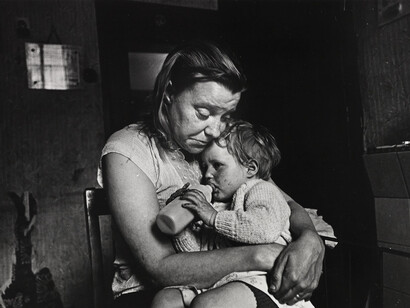 Mrs T and her family of 5 lived in a decaying terraced house owned by a steelworks. She had no gas, no electricity, no hot water, no bathroom. Her cooking was done on the fire in the living room. Sheffield, May 1969 © Nick Hedges / National Media Museum, Bradford
