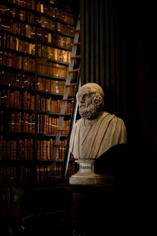 Homer’s bust surrounded by preserved volumes, symbolizing the historical continuity of ideas, stories, and written culture