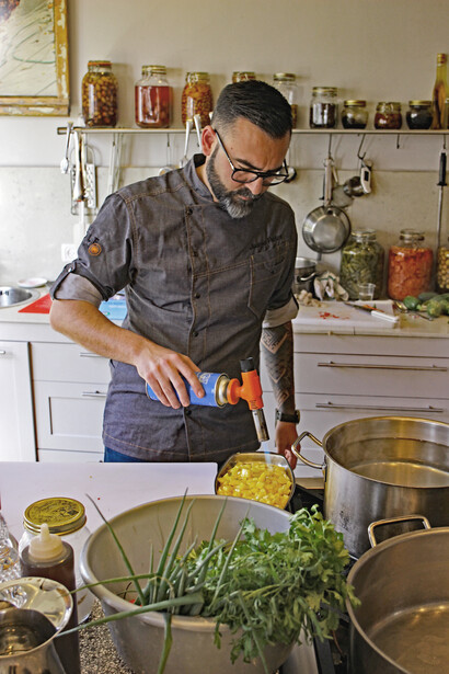 Spanish Chef Juanjo Perles uses a blow torch at The Jerusalem Atelier kitchen. Photo by Carrie Hart