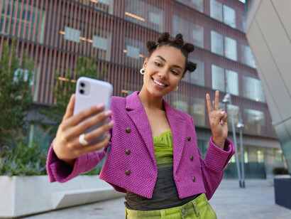 A young woman recording a playful moment to engage with followers