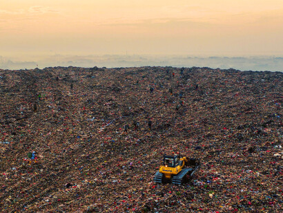 Layers of waste compacted into the earth, highlighting the long-term effects of unsustainable practices