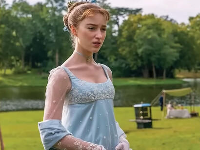 Daphne Bridgerton of Bridgerton dressed in a pale blue gown with floral embroidery and sheer sleeves, symbolizing the appeal of delicate feminine detailing