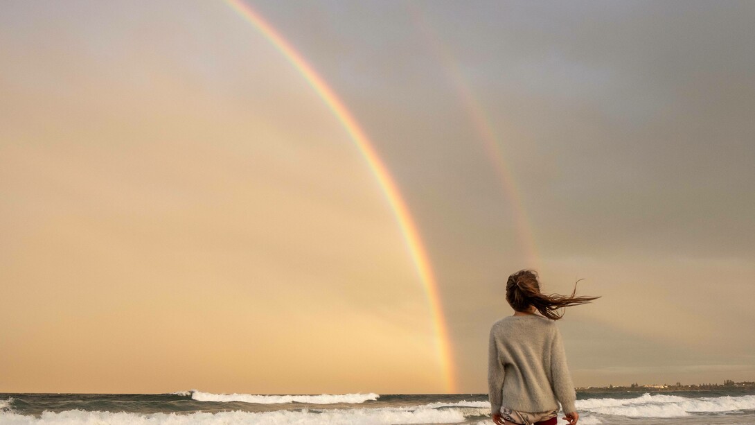 A double rainbow witnessed in solitary on the beach