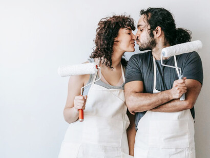 Surrounded by drop cloths and tools, they share a kiss amidst the organised chaos, revelling in the adventure of making their house a home together