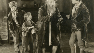 Szene von „Oliver Twist“, Verfilmung aus dem Jahr 1922. Jackie Coogan (zweiter von  Links) verkörpert Oliver Twist im Film