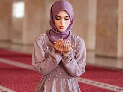 Young woman praying inside a mosque in Jakarta, Indonesia