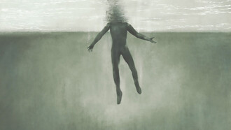 A surreal image of a man submerged underwater, symbolizing the fight for breath