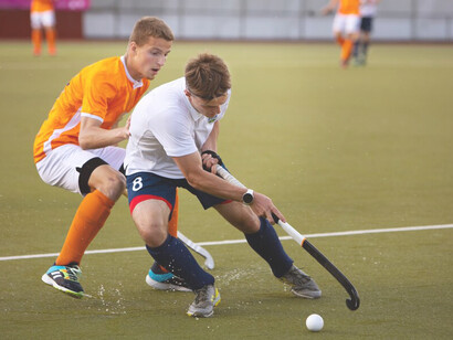 Exciting action of field hockey players during a tournament match