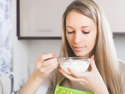 A woman eating cottage cheese