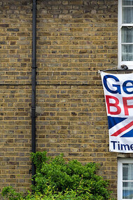 A brown brick building in the United Kingdom with a white fabric banner reading "Get Britain Out, Time to Leave the EU," reflecting the sentiment of the Brexit movemen