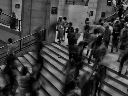 Black and white image of a crowded staircase filled with people