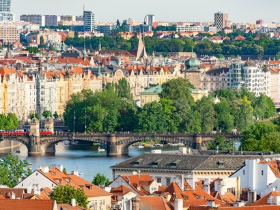 A sweeping view of Prague’s rooftops, bridges and riverside architecture, representing the city’s picturesque character