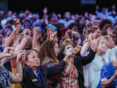 People assembled in a church setting, capturing the enduring presence of faith in contemporary public life