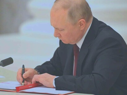 Vladimir Putin composing a letter to Jeffrey Levett