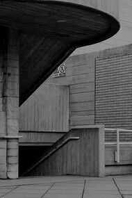 The rugged beauty of the Brutalist staircase invites reflection on the enduring legacy of concrete structures, now evolving to meet modern sustainability standards